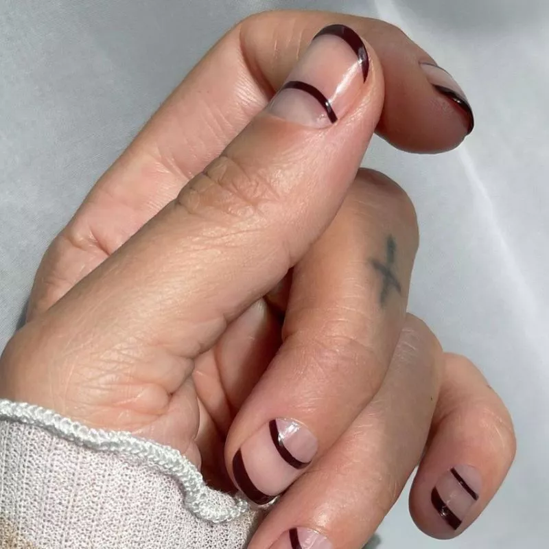 Double French manicure with neutral base and burgundy tips