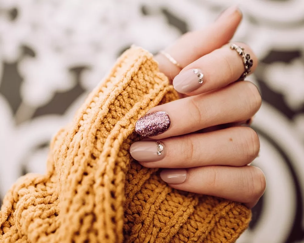 female hand manicure sweater