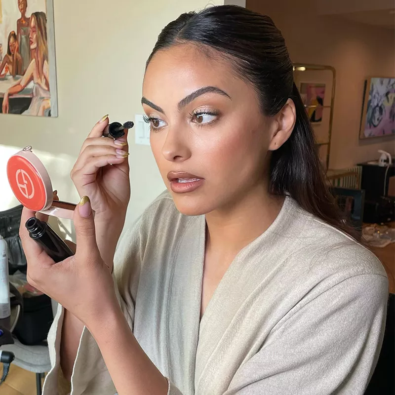 Camila Mendes applying makeup