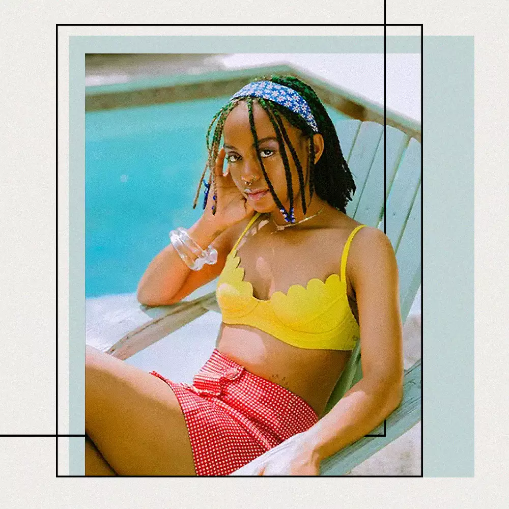 BIPOC Woman Sitting by a Pool in a Retro Inspired Bathing Suit 