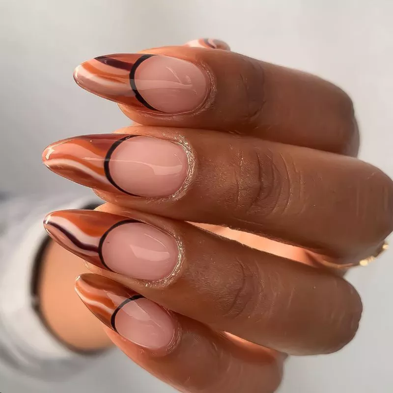 French manicure with wavy lines in different shades of brown on the tips