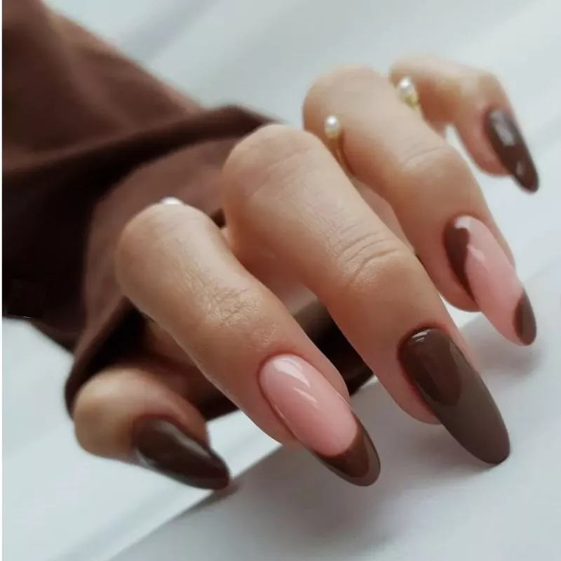 Brown manicure with French tip and negative space accent nails