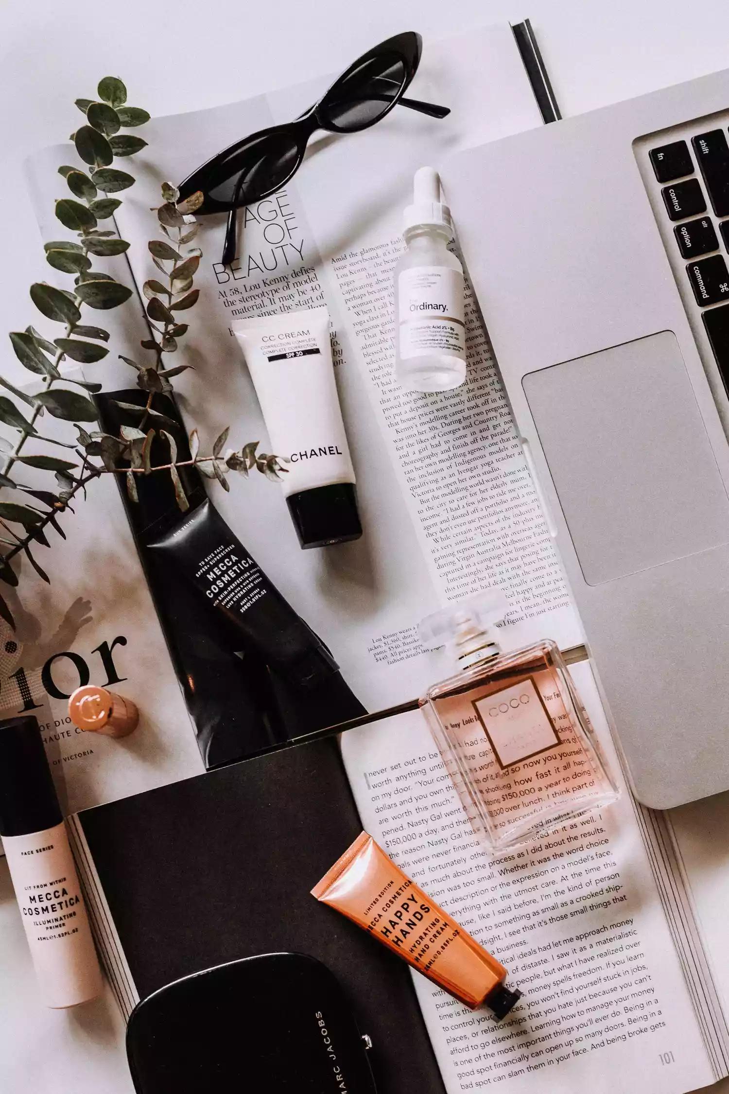 beauty products on a desk with computer