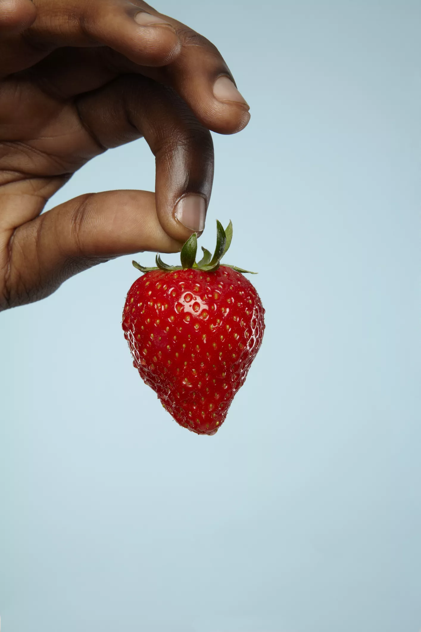 closeup of strawberry in fingers