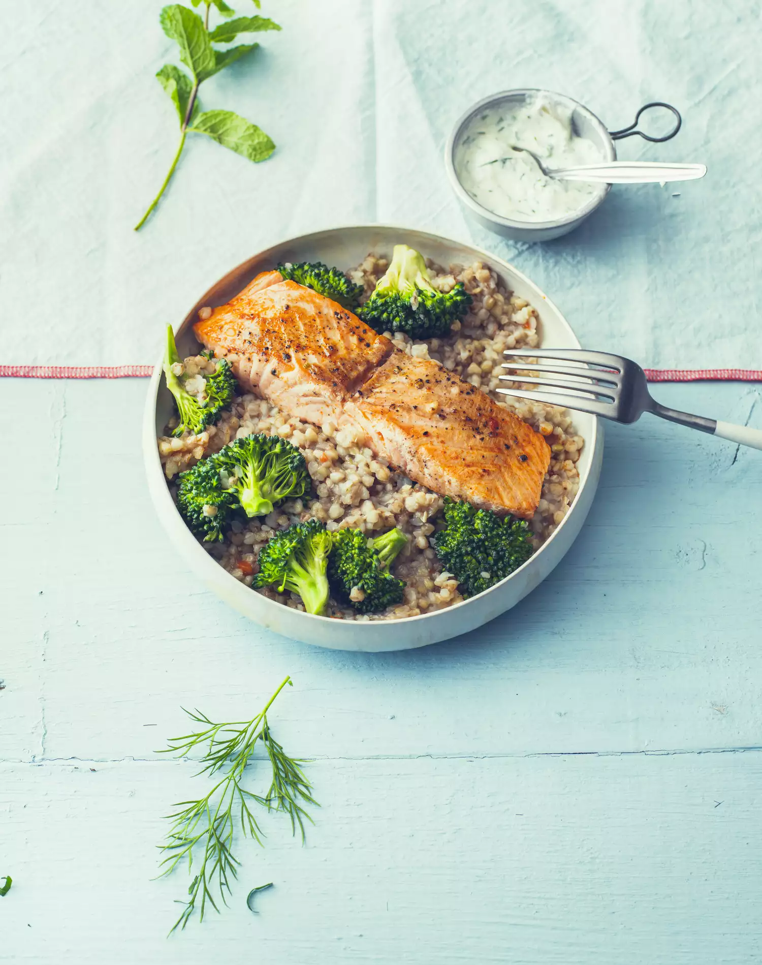 salmon with buckwheat pilaf and broccoli in a bowl