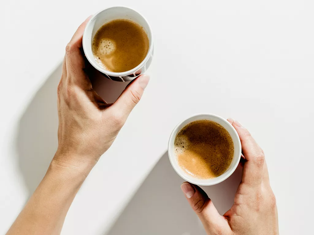 Cups of coffee on a white background