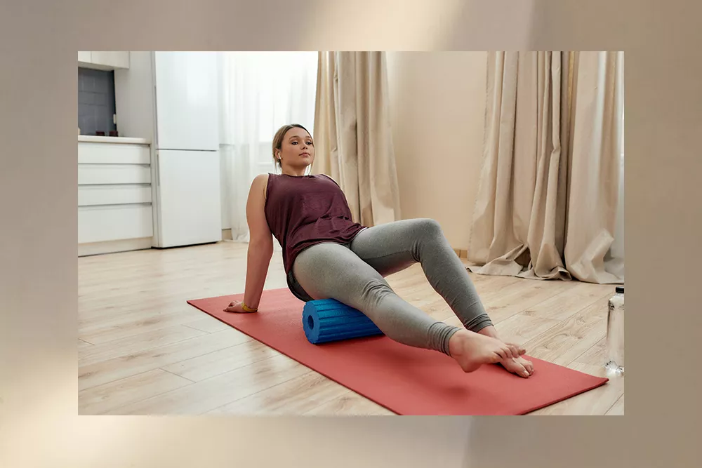 Woman using a foam roller in her apartment