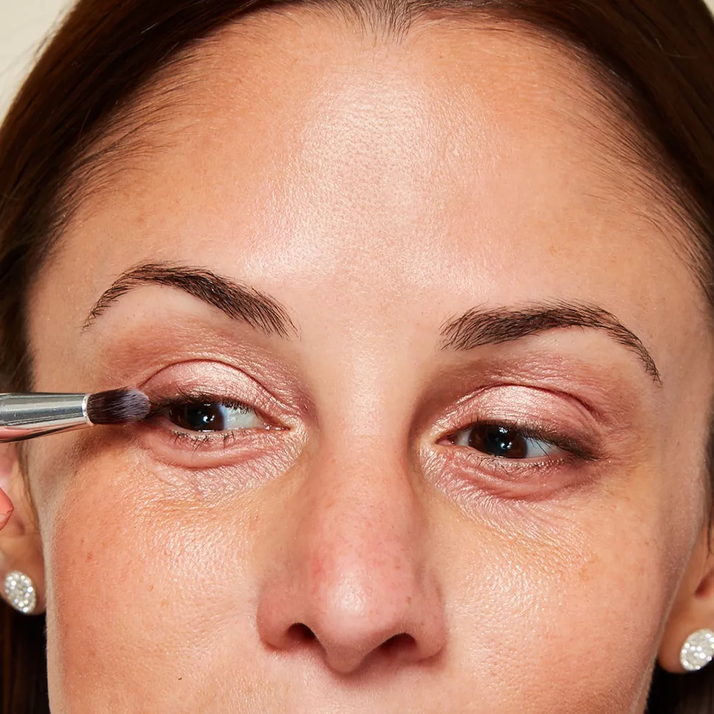 Woman with mature skin applying eyeshadow