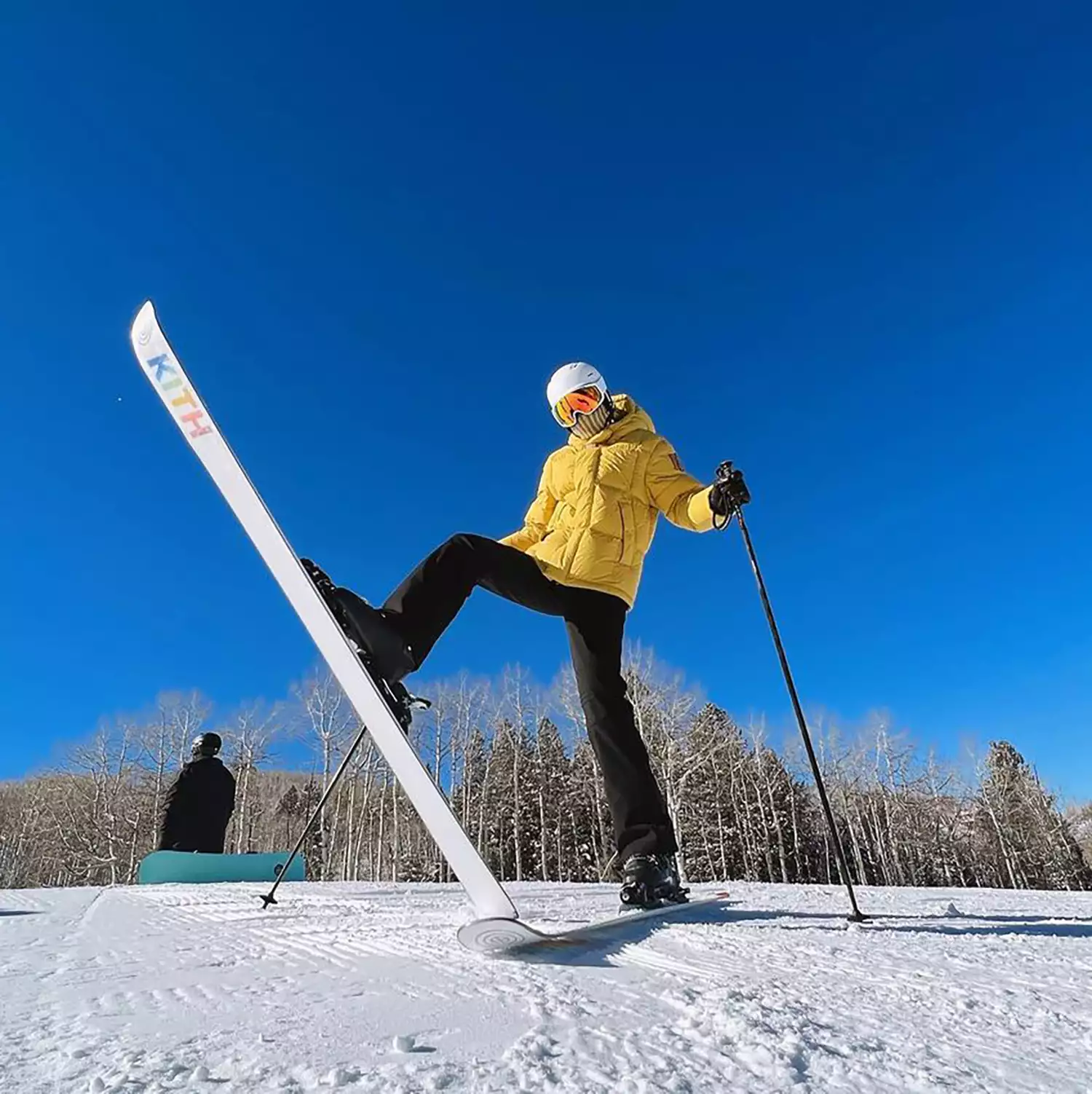 Close up of Gigi Hadid with skis, one ski in the air