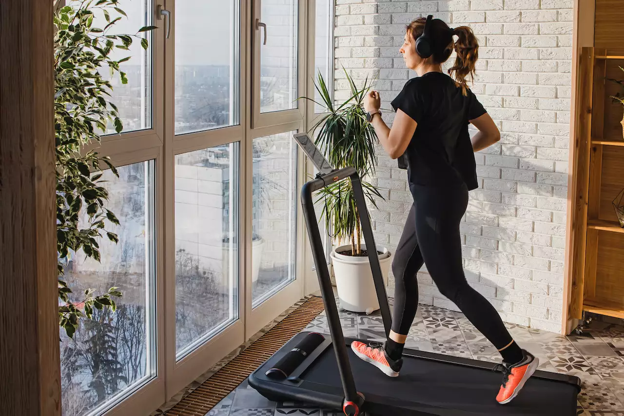 Woman running on a treadmill in her home