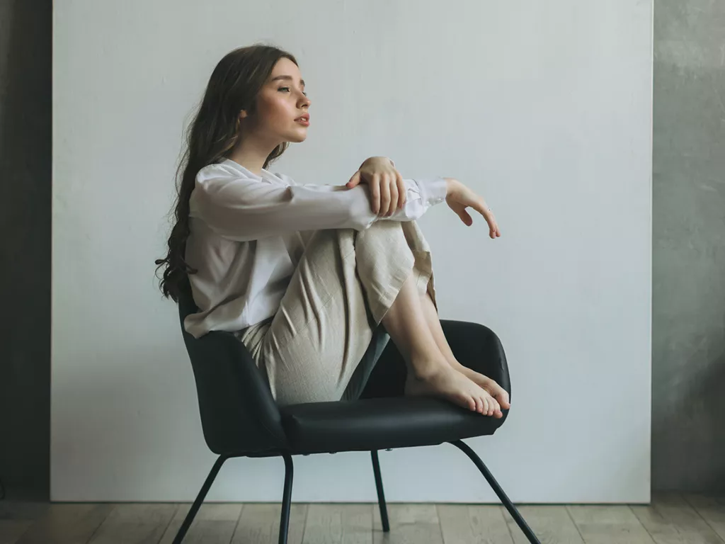 Woman sitting in a chair looking into the distance