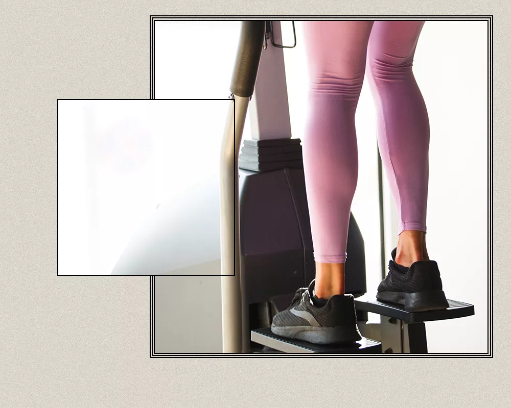 Close up of a woman's feet and legs on a stair stepper