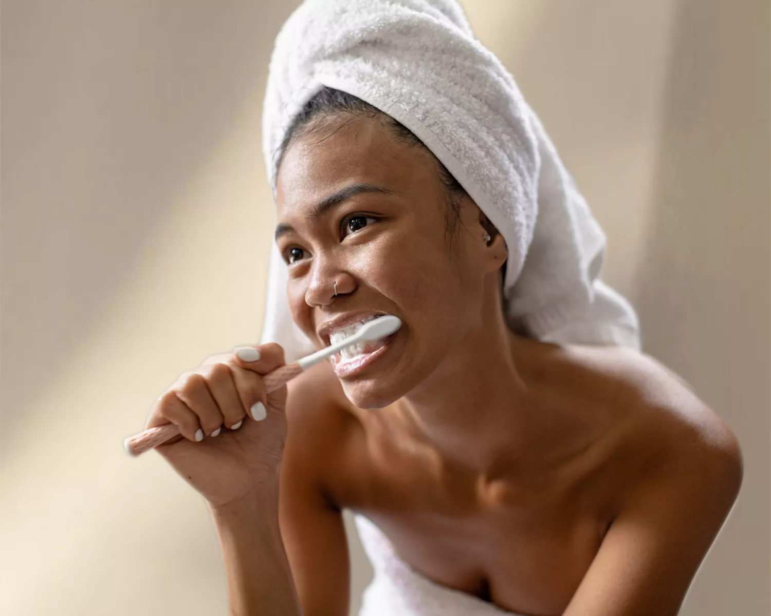 woman brushing her teeth on textured background