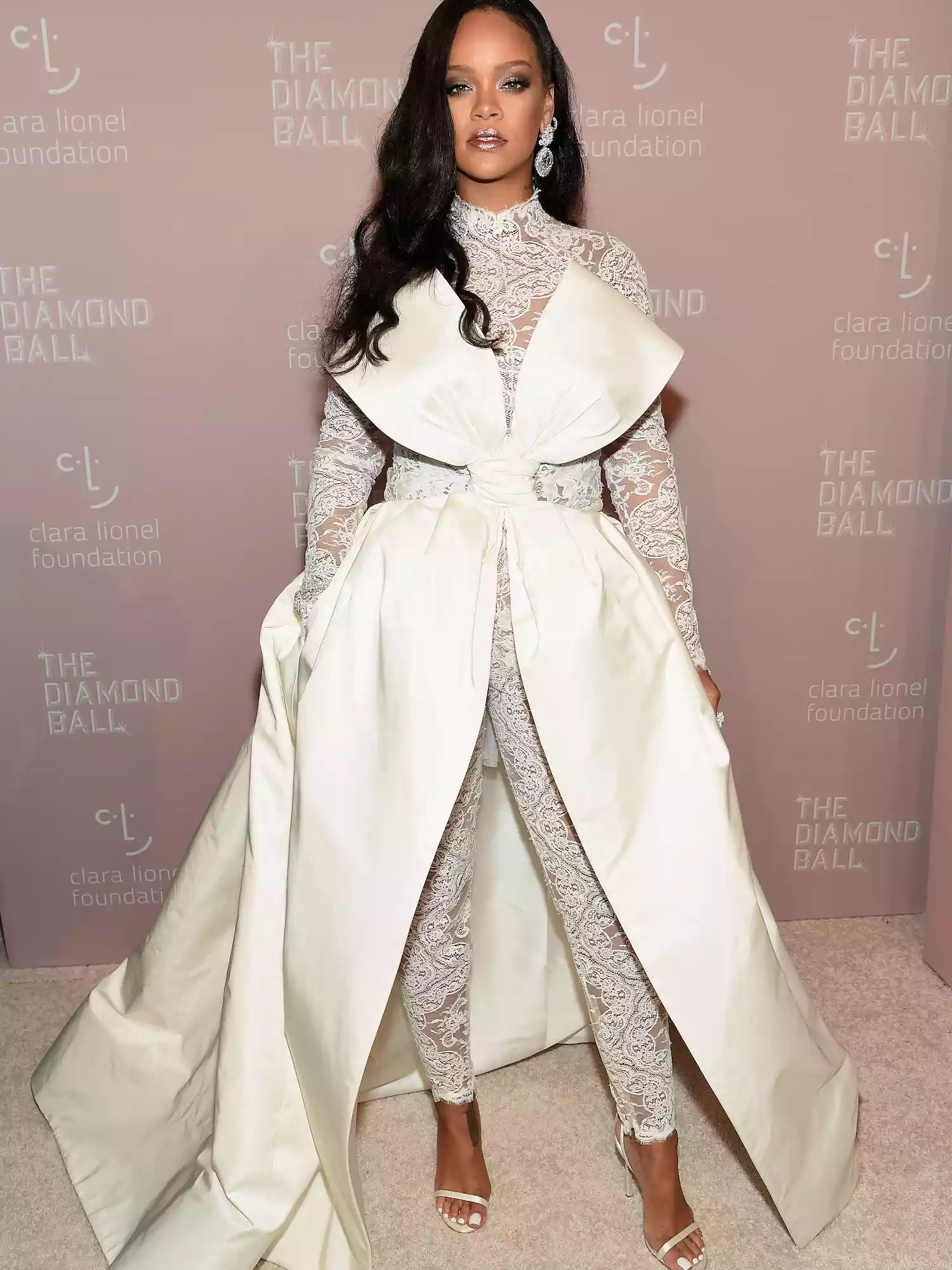 Rihanna wears a lace catsuit with oversized bow and overskirt to her 4th annual Diamond Ball