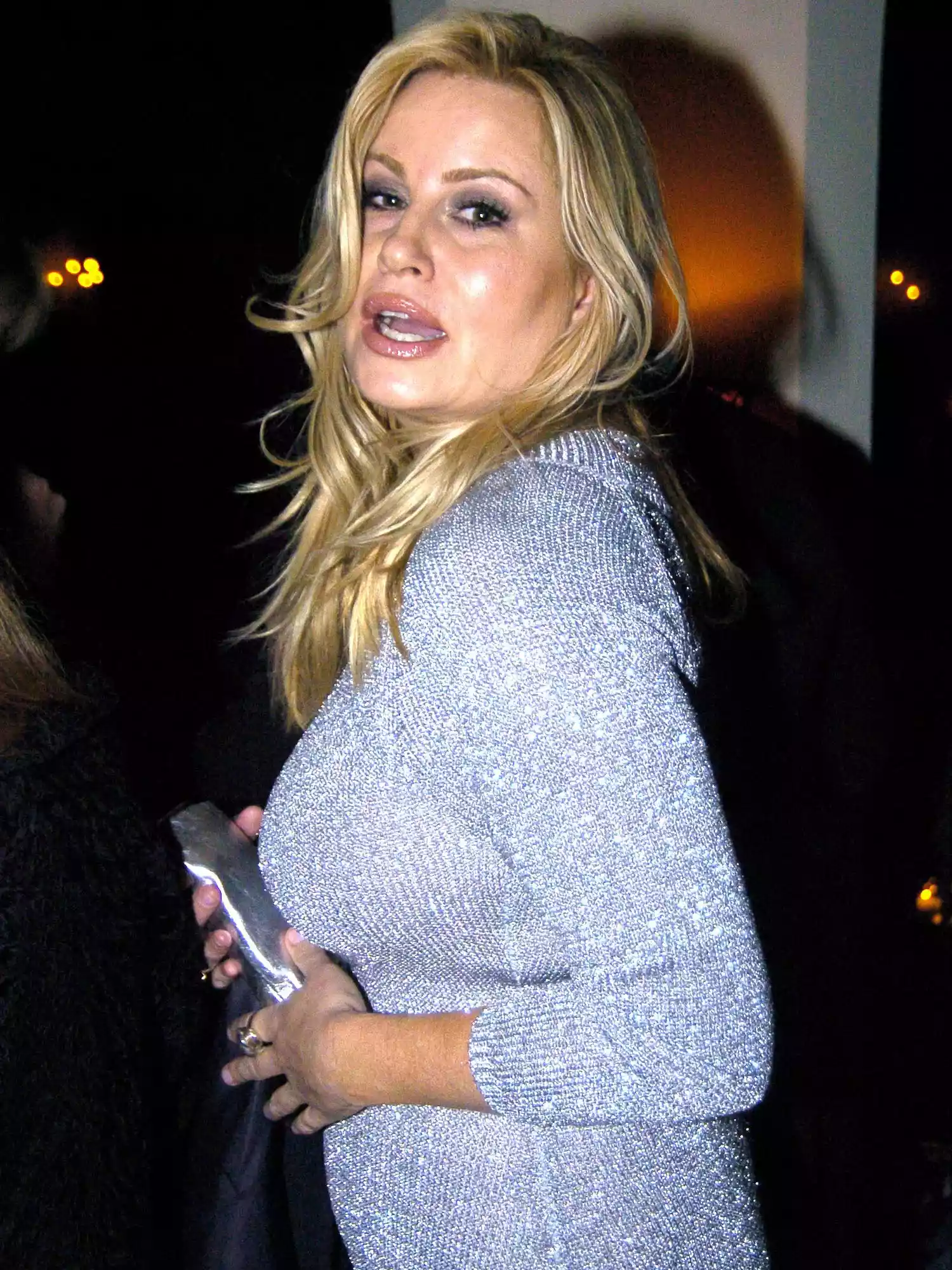 Jennifer Coolidge wears a silver knit dress, shiny cluch, and smoky eyeshadow to HBO's Pre-Golden Globes Party