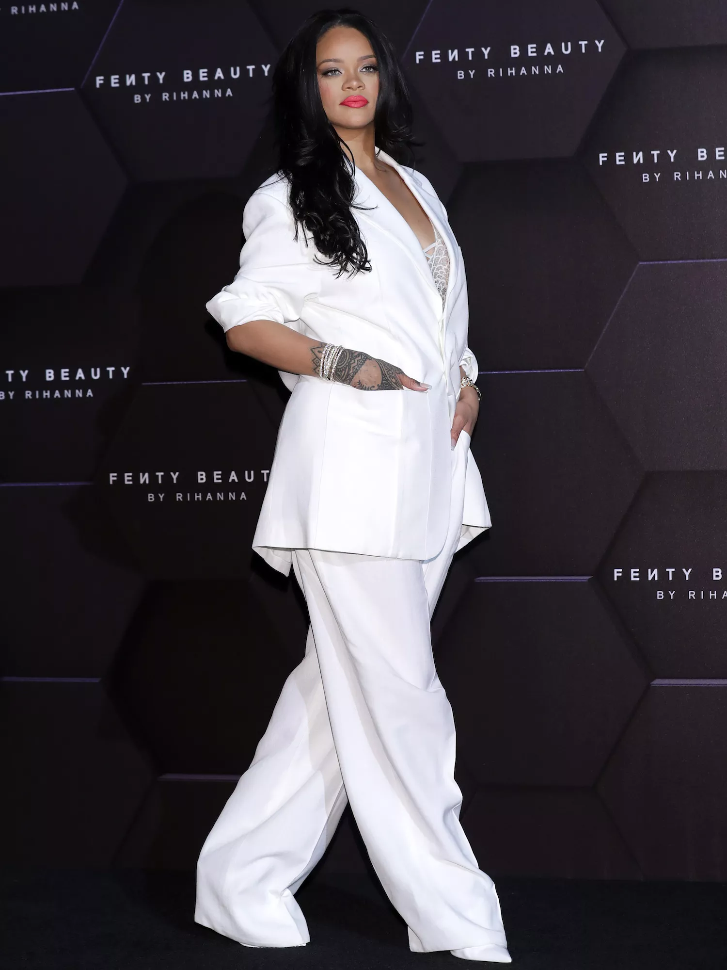 Rihanna wears a white pantsuit to the Fenty Beauty artistry talk in Seoul in 2019