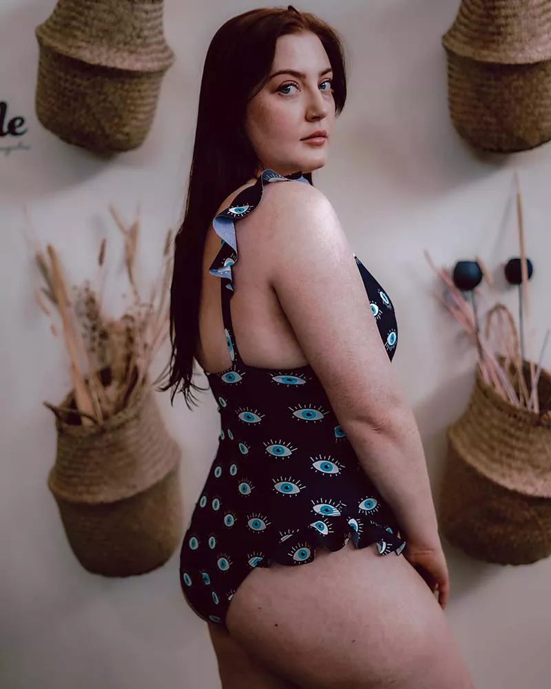 Model wearing floral one-piece swimsuit