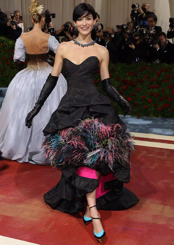 Grace Elizabeth wearing a feather-trimmed black gown at the 2022 Met Gala.