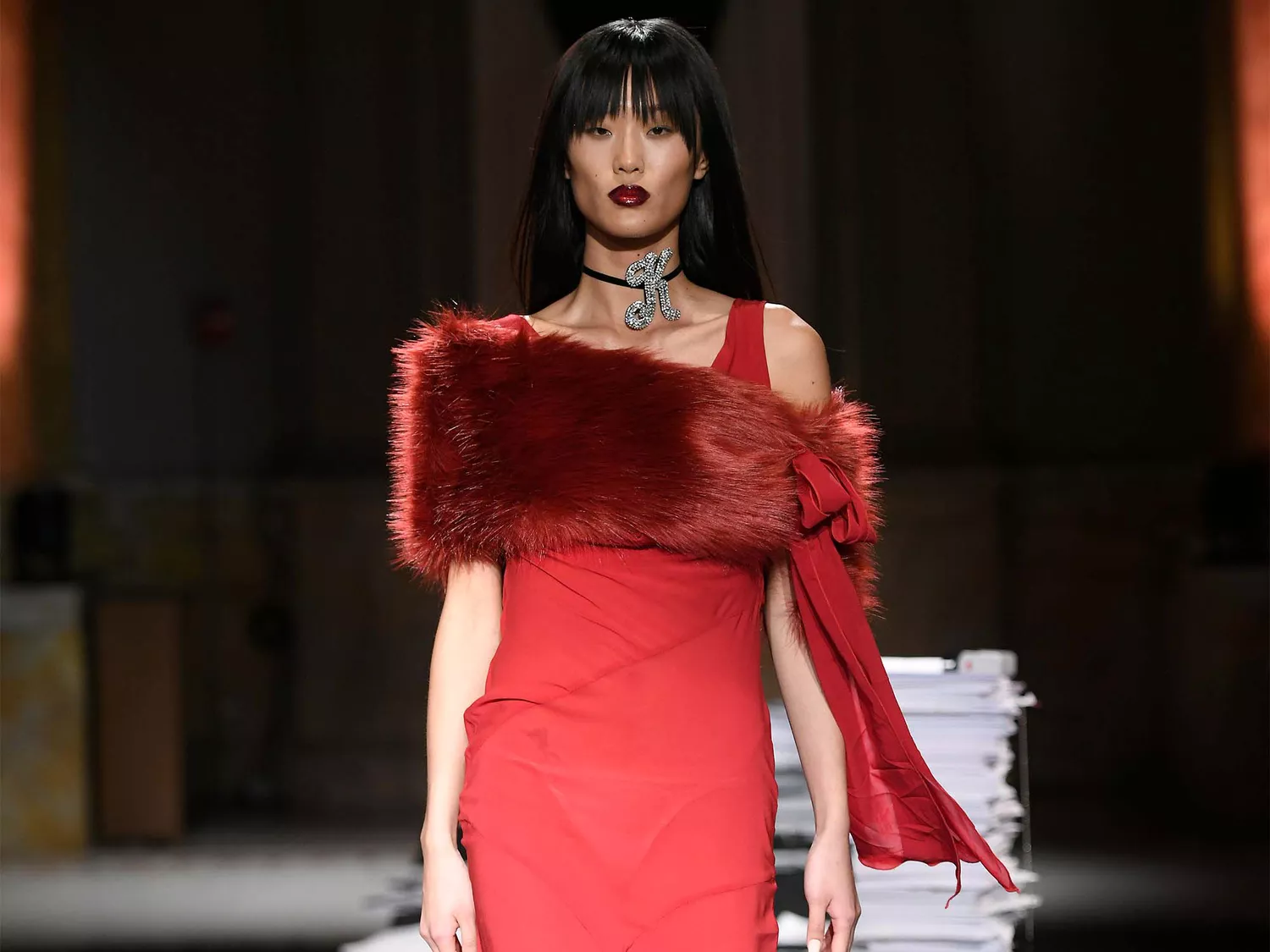 Model wearing a red dress at Kim Shui.