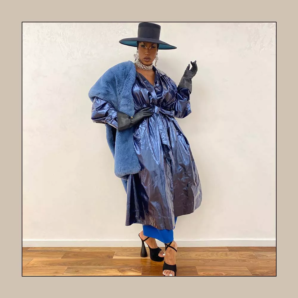 Shea Coulee wearing a blue jacket and fur.