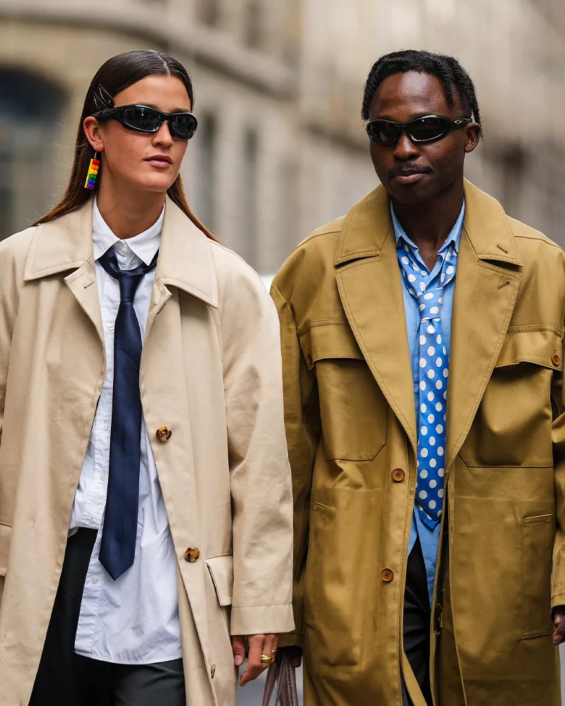 two people in trench coats and ties