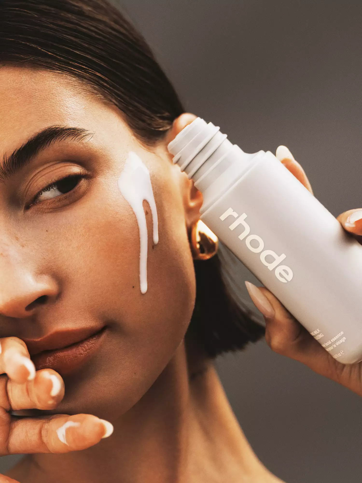 Hailey Bieber with new Rhode Glazing Milk on her face