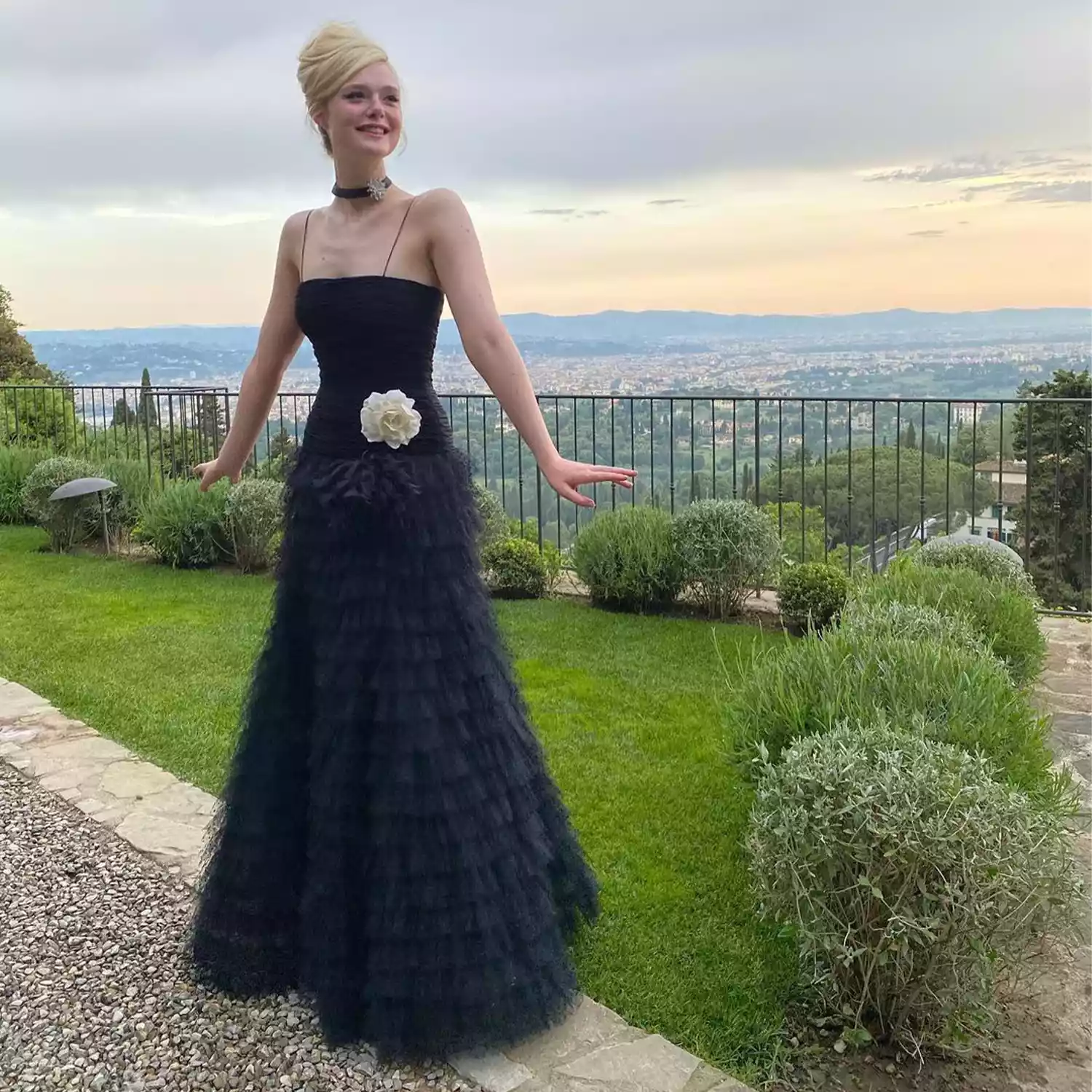 Elle Fanning in a black dress and baby beehive 