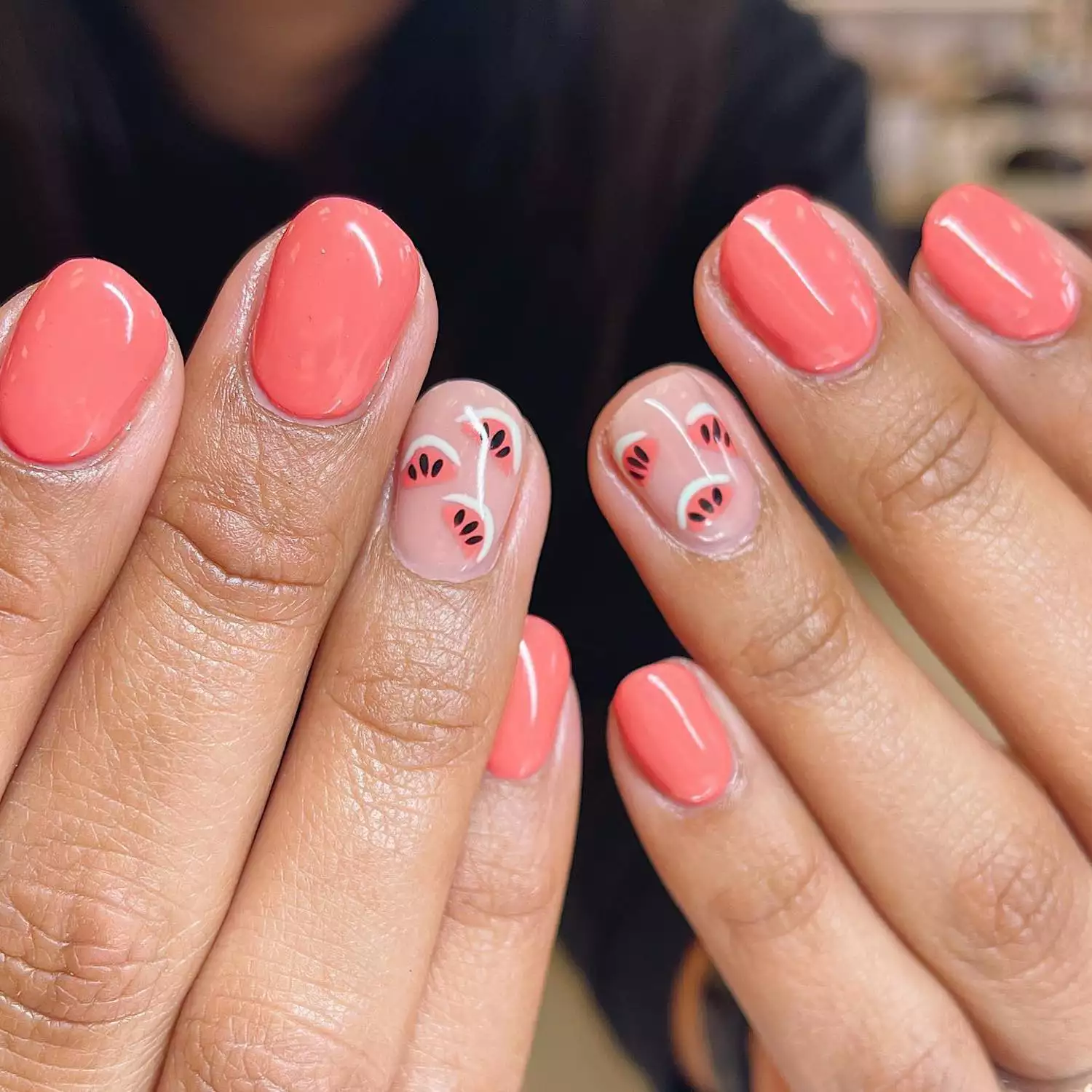 Peach-colored manicure with accent watermelon nails with white rind detail