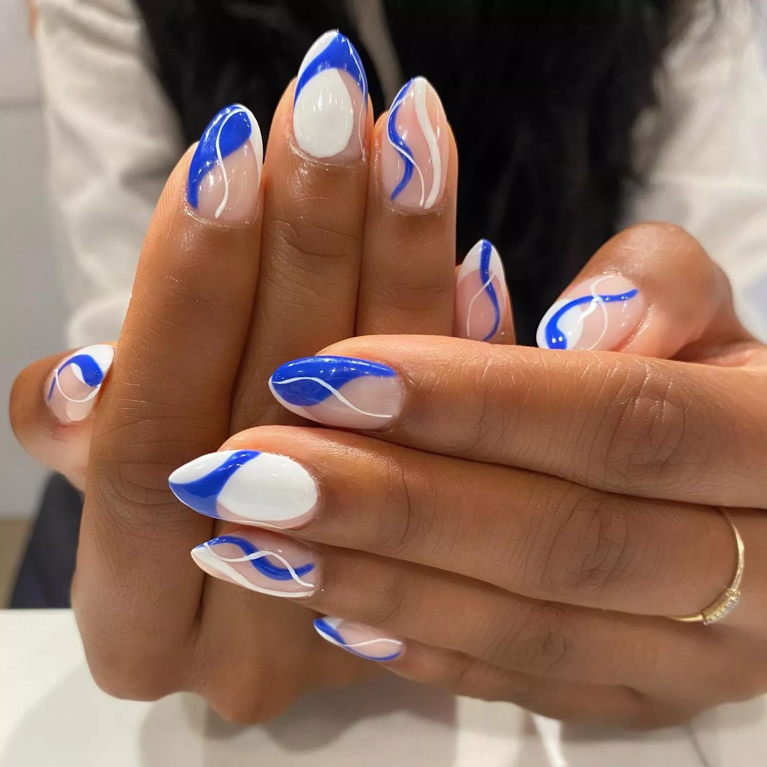 Manicure with blue and white wave and line designs