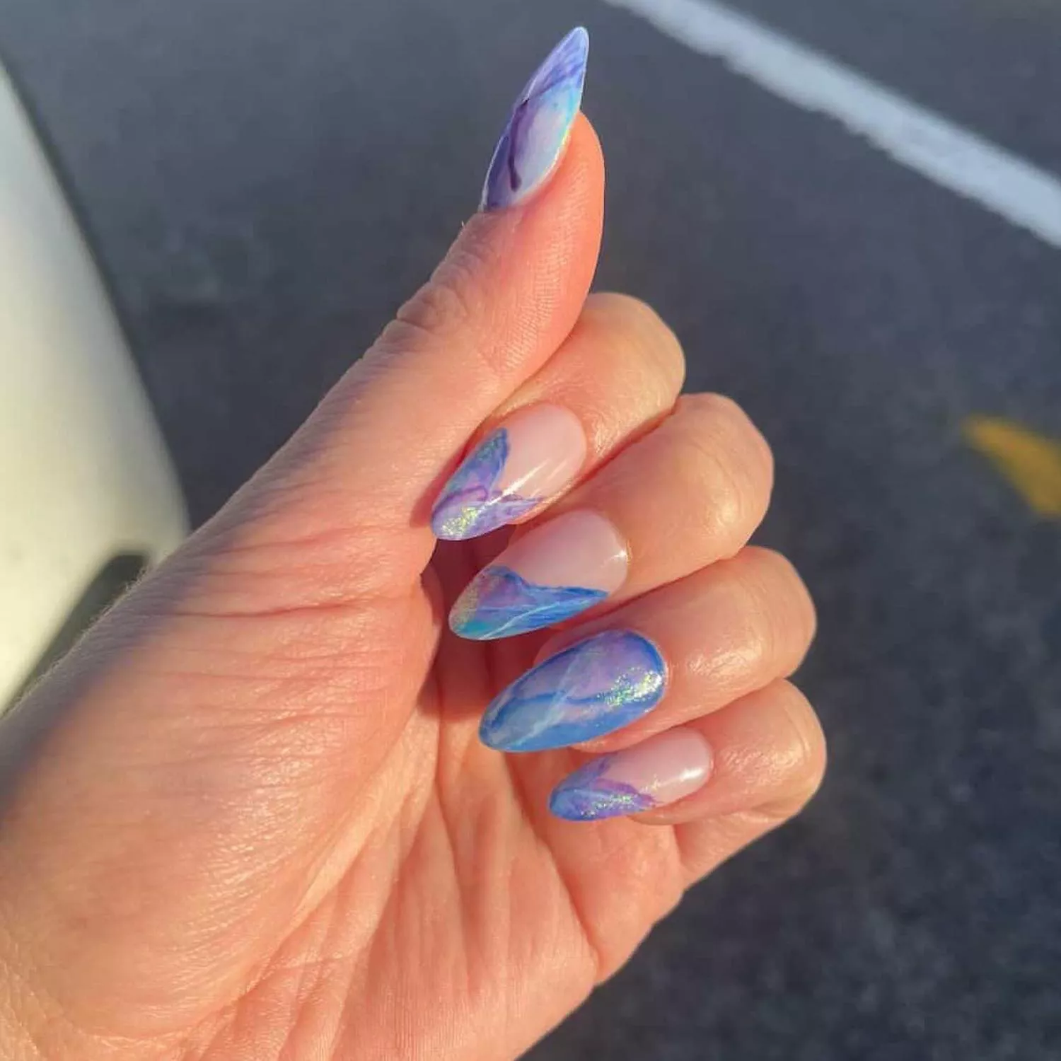 Manicure with chrome blue and purple abstract marbled details