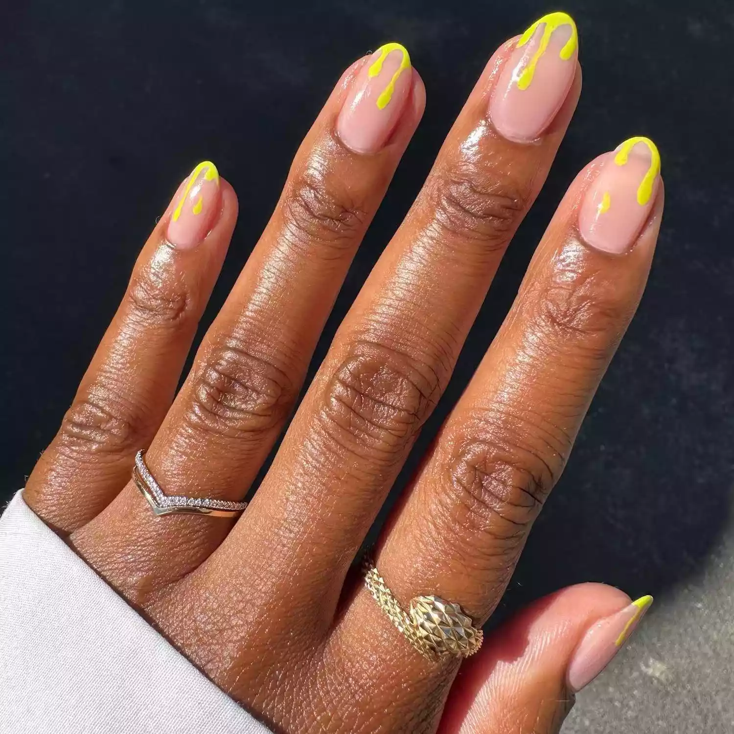 Manicure with pale pink base and yellow-green slime detail