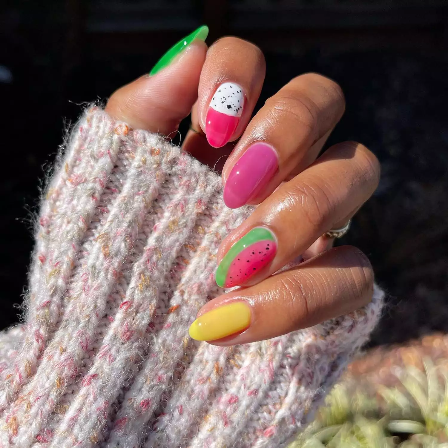 Manicure with watermelon and dragonfruit-inspired designs plus lime green, pink, and yellow solid nails