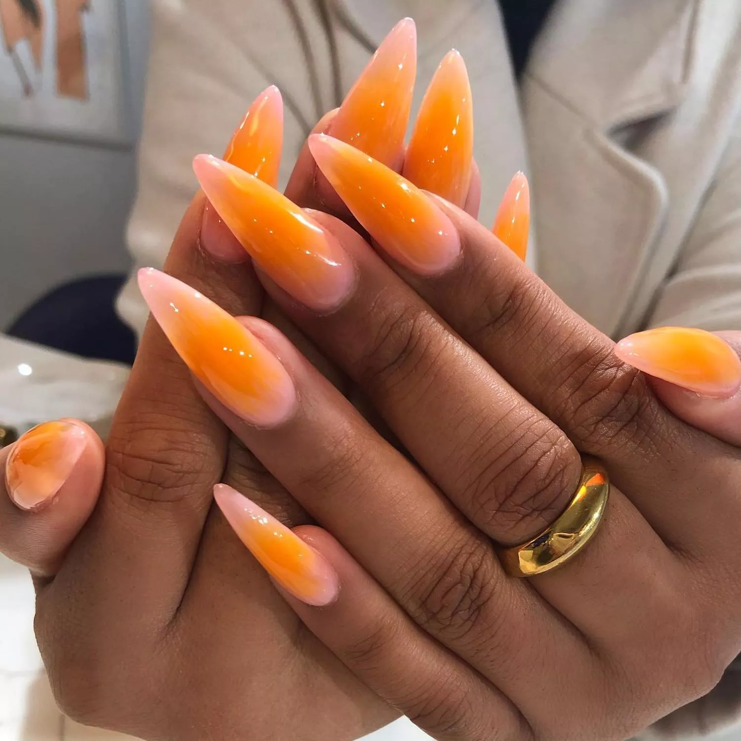 Elongated manicure with orange and pink ombre aura design