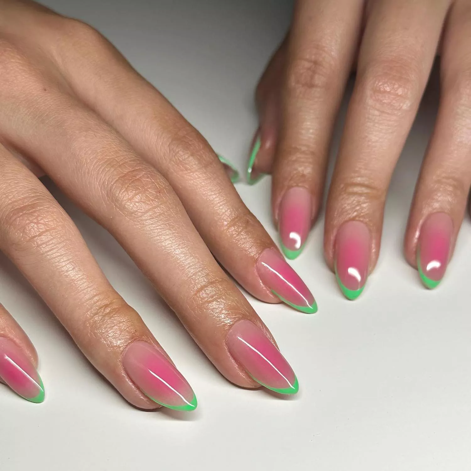 Manicure with watermelon pink airbrushed base and lime green French tips