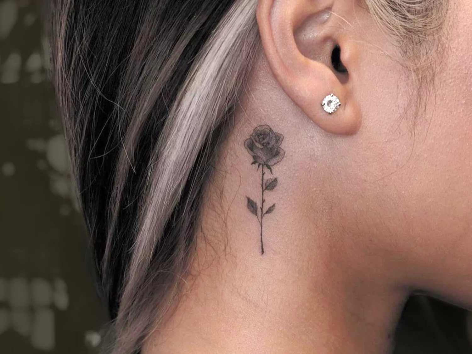 Woman with Rose Tattoo on her Neck Behind Her Ear