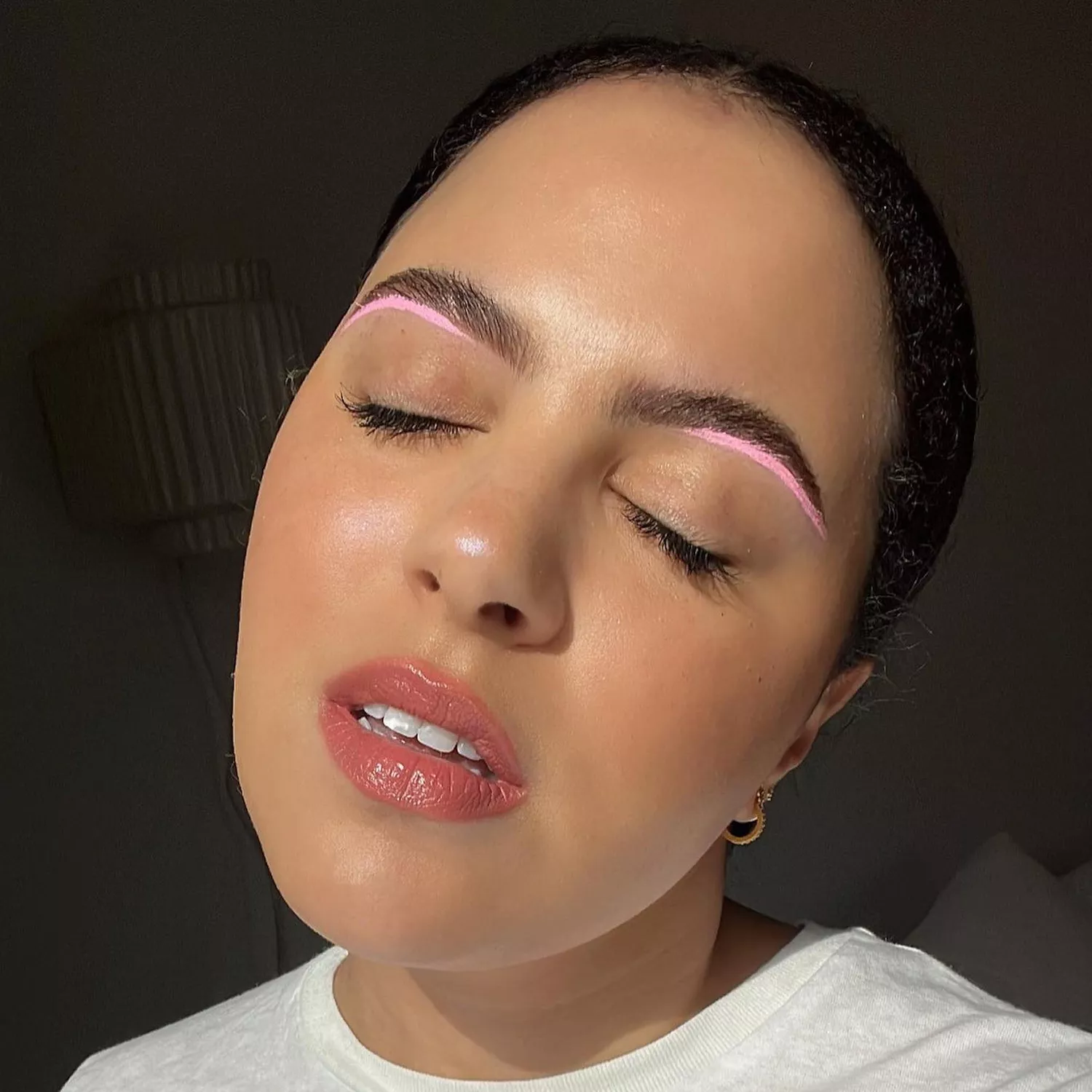 close up of woman's face with light pink shadow under brows 