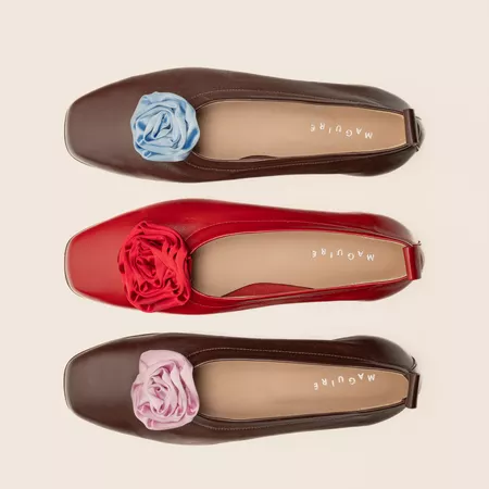 Three ballet flats with different color rosette detailing
