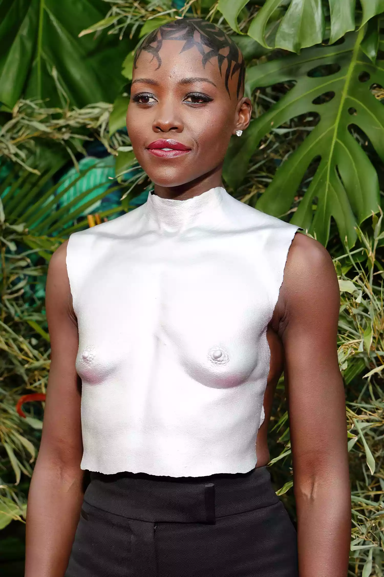 Lupita Nyong'o at the 2023 Tony Awards wearing a silver breastplate