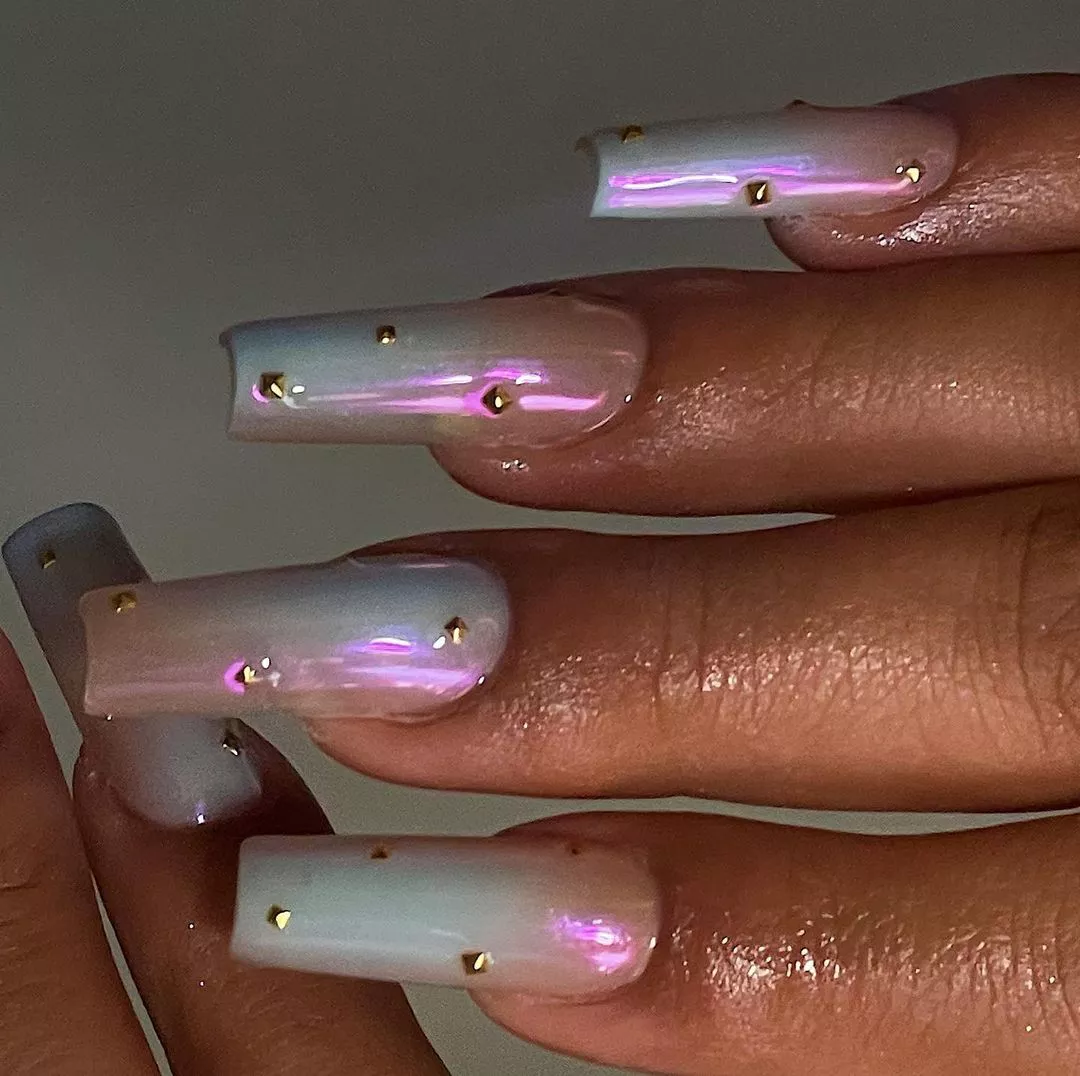 Manicure with iridescent base and stud accents