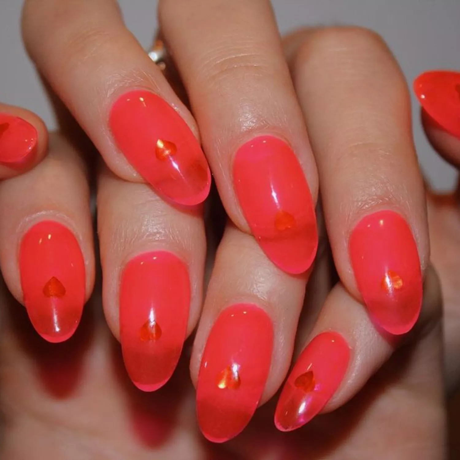 A neon spritz manicure on oval nails, viewed up close