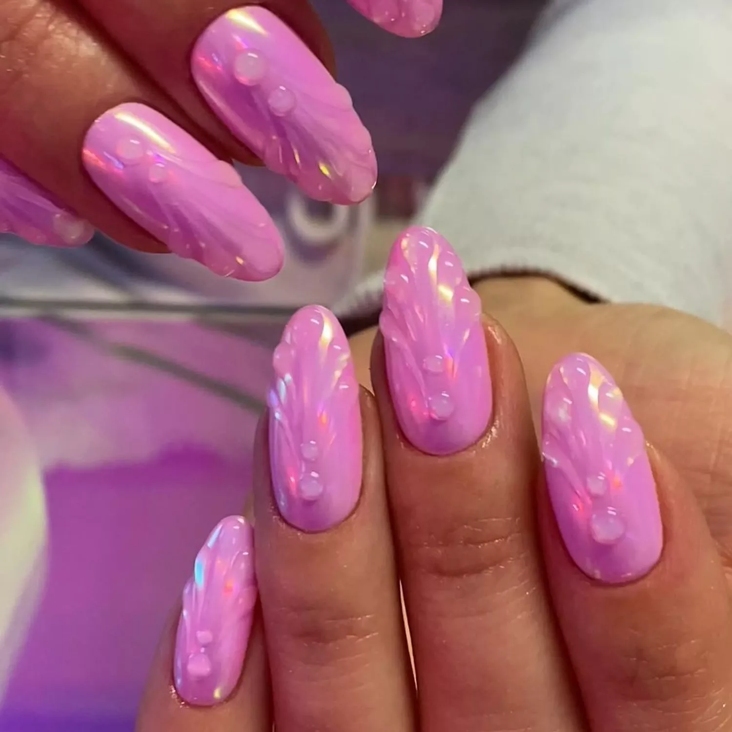 Bubblegum pink manicure with sculpted mermaid shell details