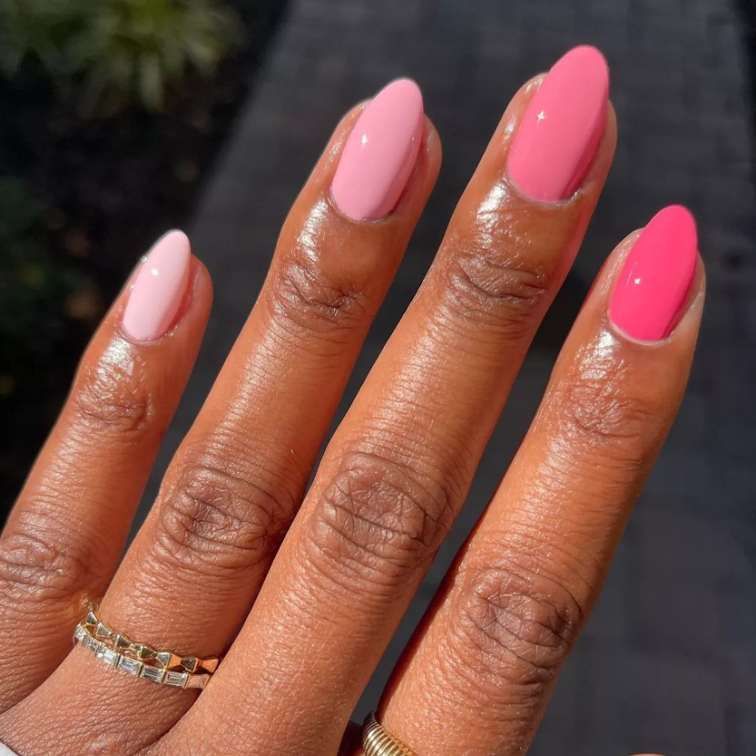 close up of woman's hand with horizontal ombre pink manicure