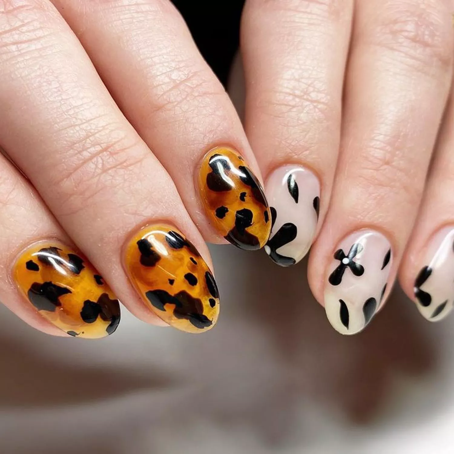 Manicure with tortoiseshell design on one hand and floral design on the other