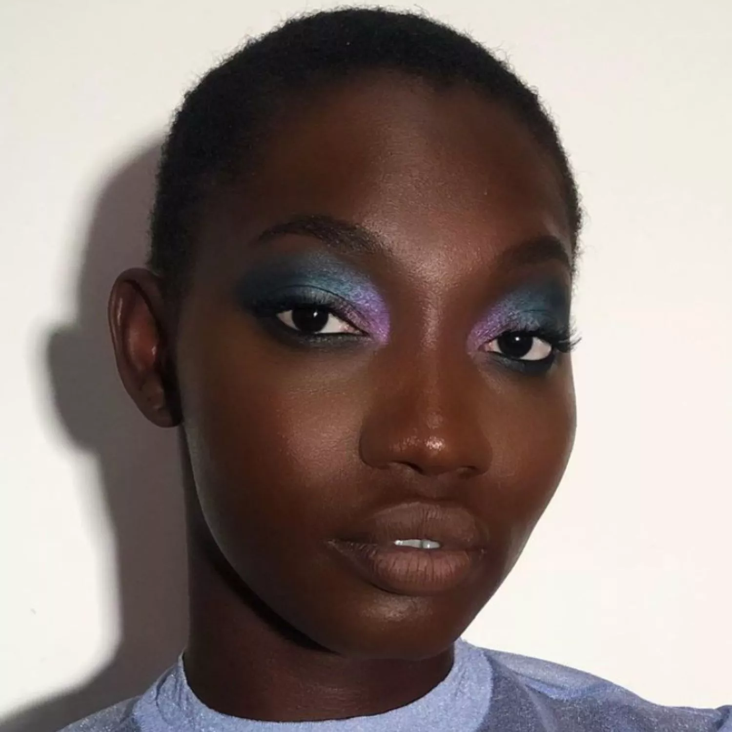 Model with blue to purple smoky ombre eyeshadow look