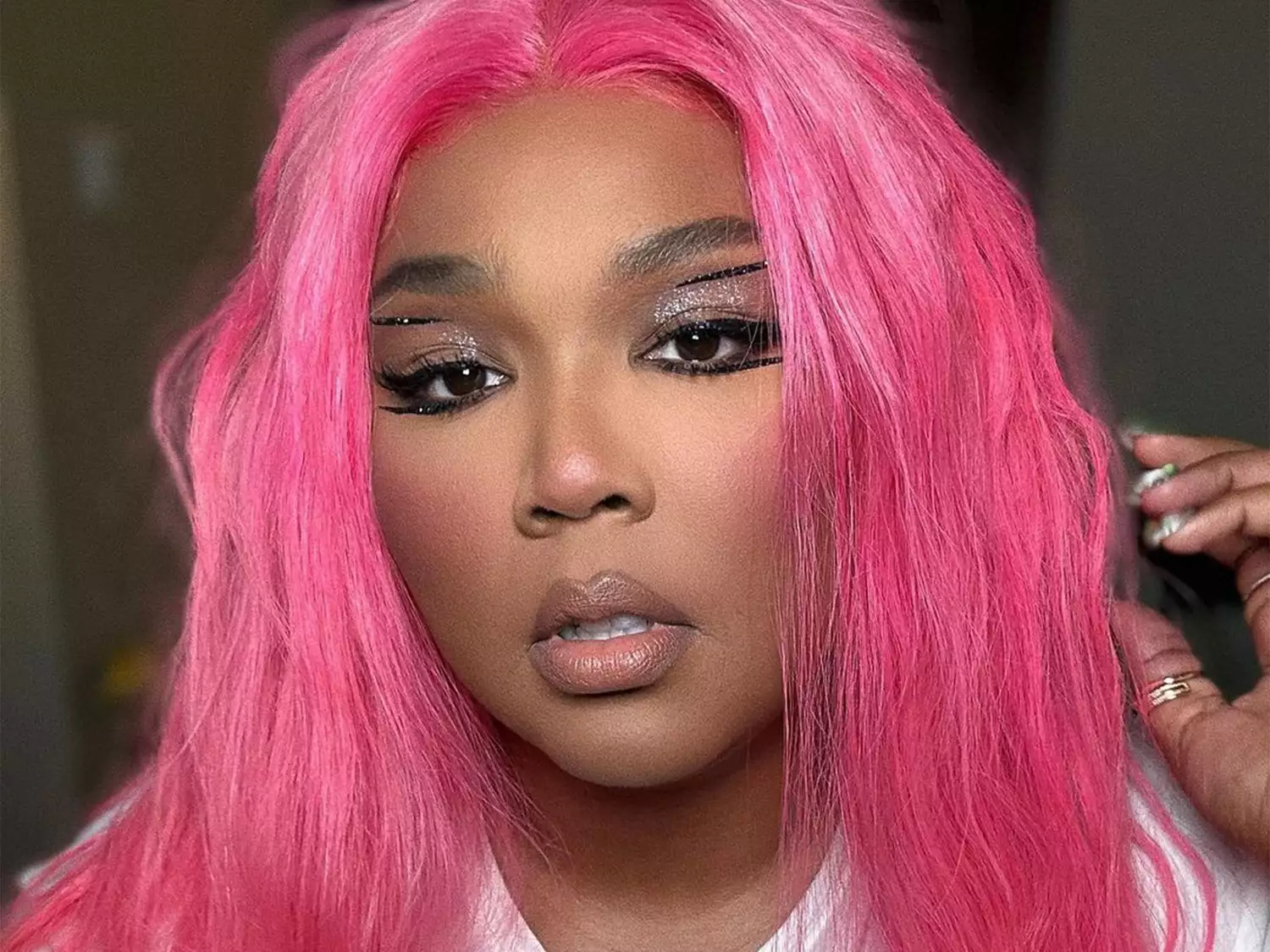 Lizzo wearing a hot pink wig and sea glass gem manicure 