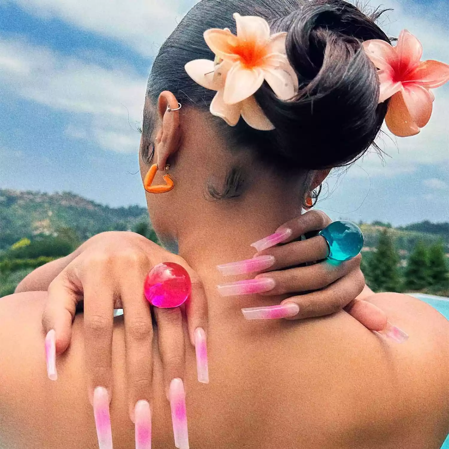 Megan Thee Stallion's floral bun and hot pink aura nails 