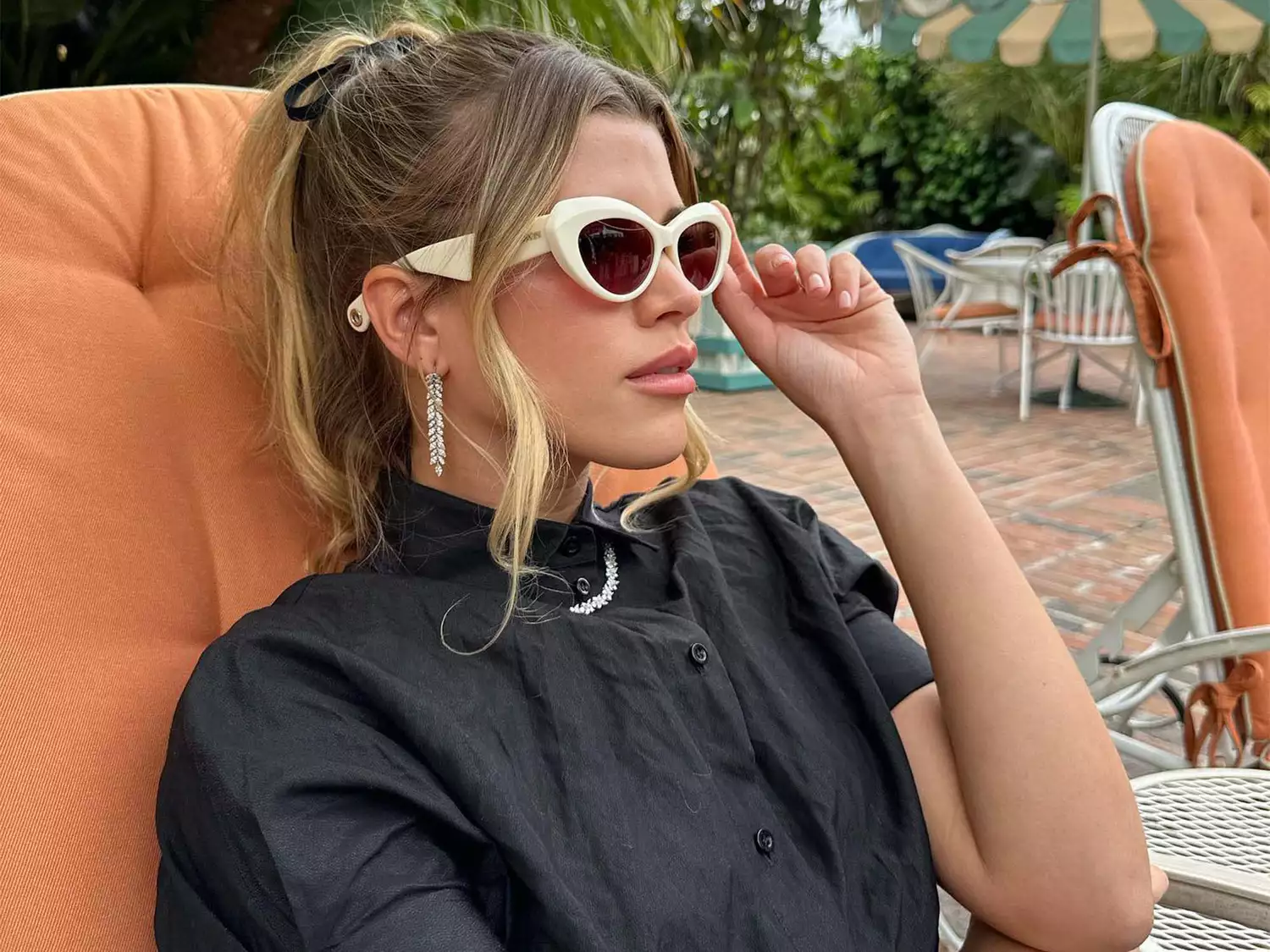 Sofia Richie Grainge wearing sunglasses by the pool