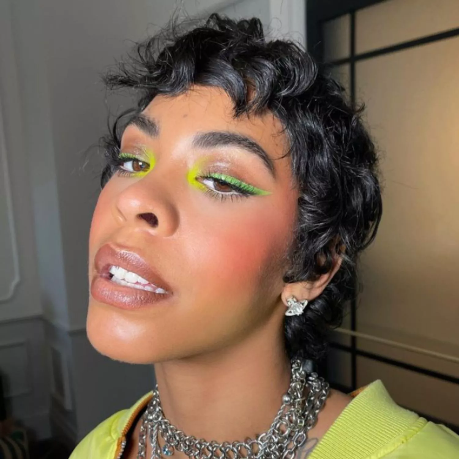 Rico Nasty with neon yellow watercolor tear duct eyeshadow and lime green winged eyeliner
