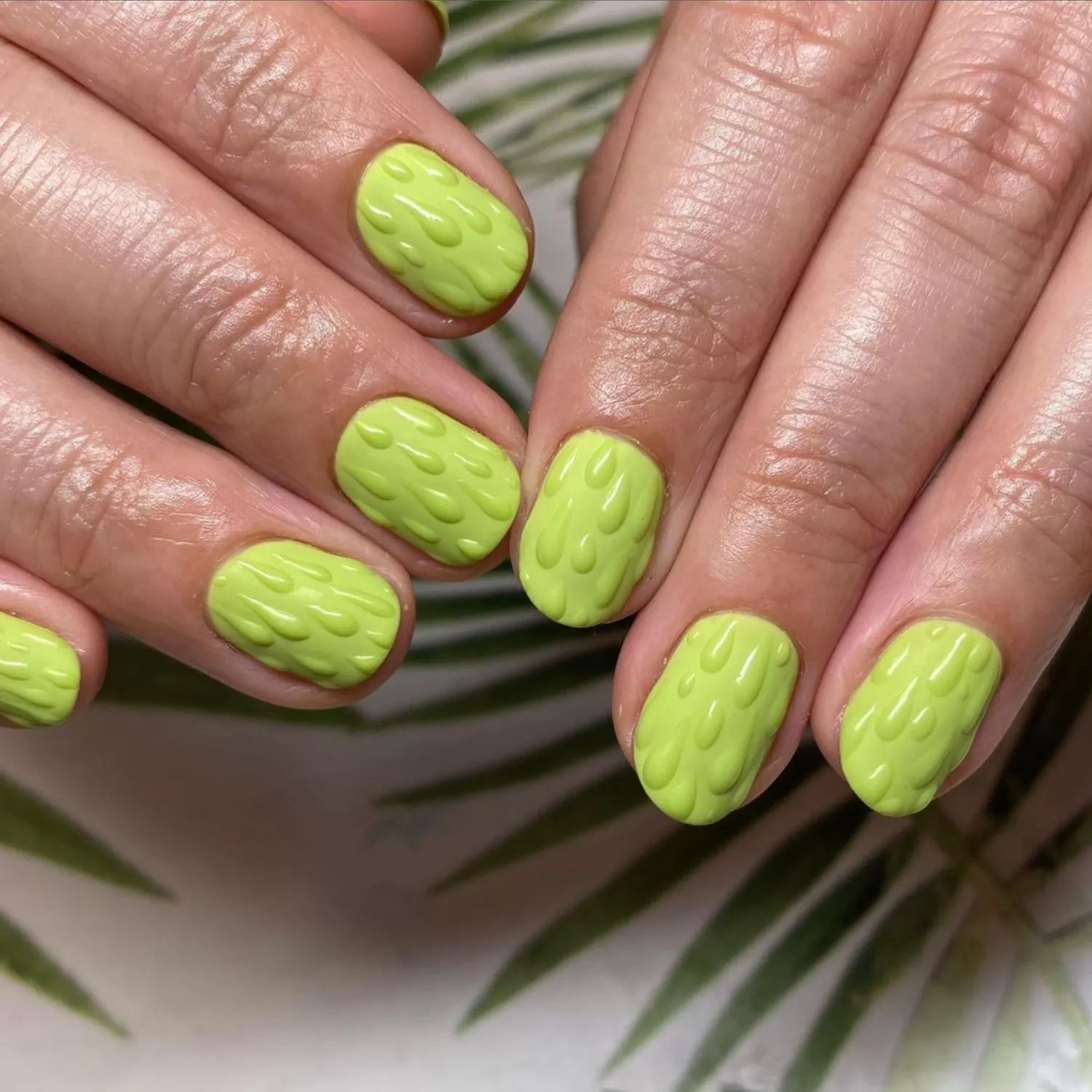 Lime green manicure with 3D slime drip design