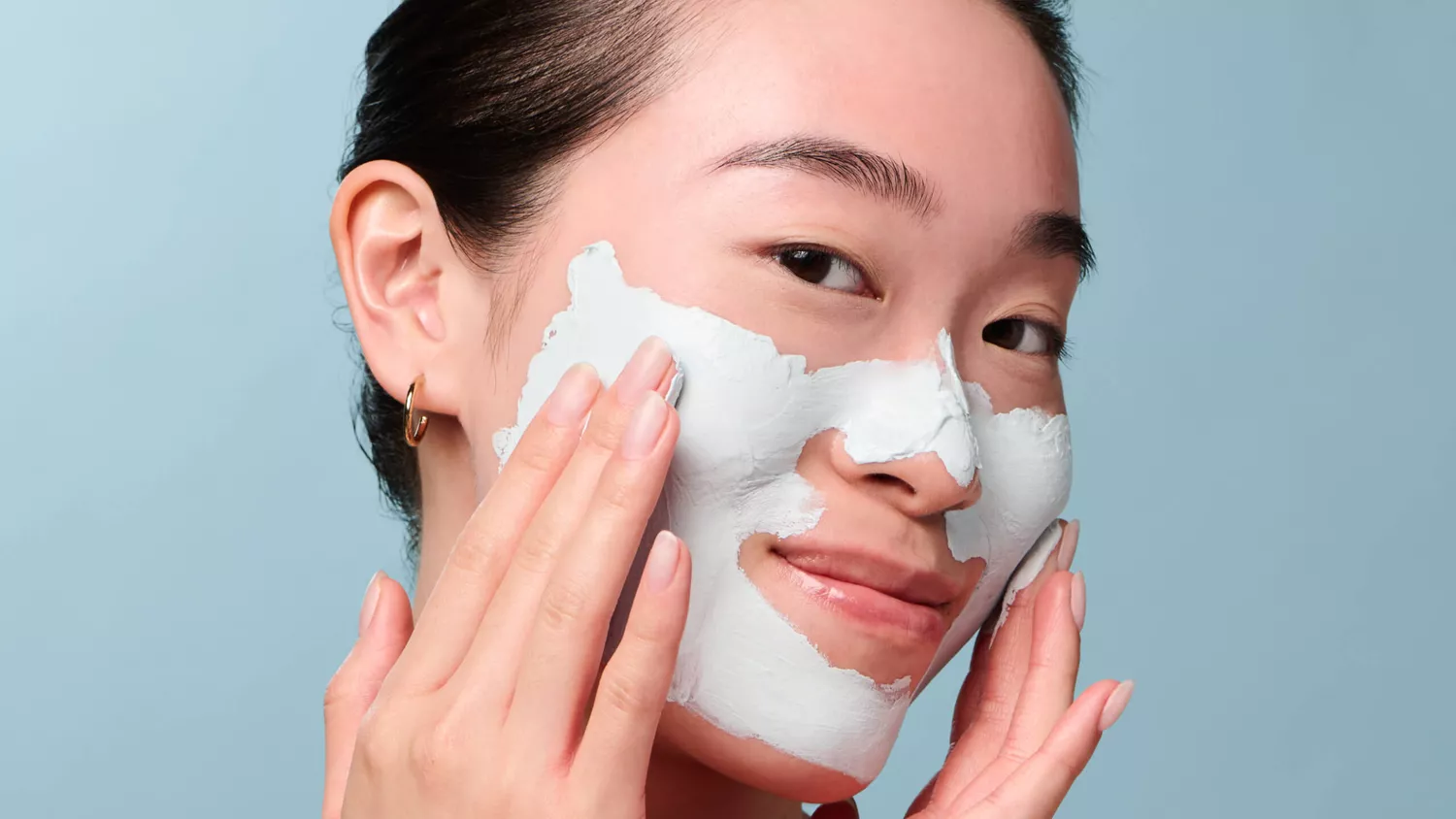 a person applying the pore purity mask